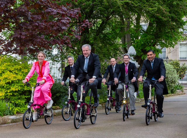 <p>Hugo Burnand (centre) and his team setting off early on Saturday morning to Buckingham Palace to take the official photographs for the coronation of King Charles and Queen Camilla </p>