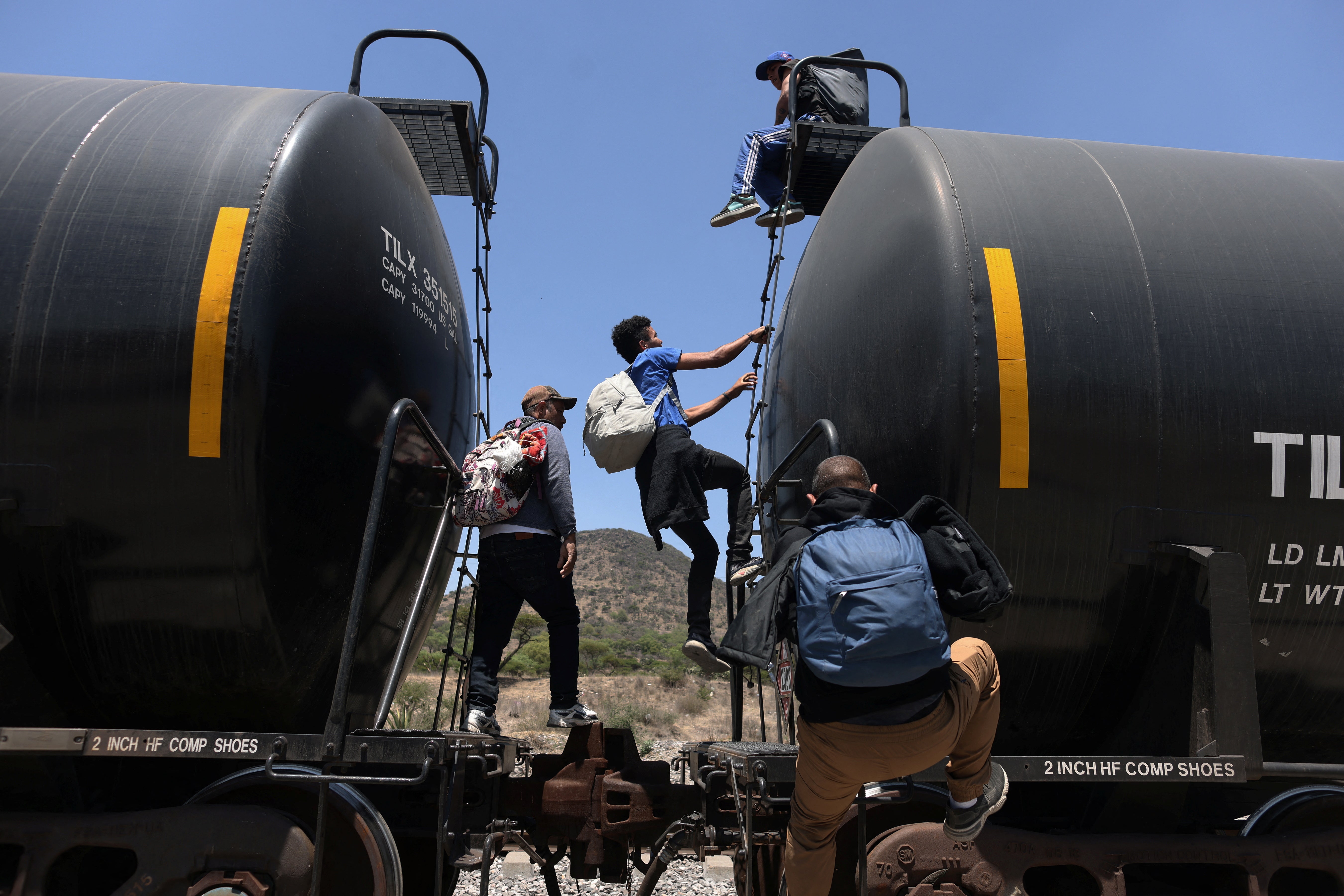 Migrants, mostly from Venezuela, get on a train at the site known as El Basurero, as they continue their journey towards the US border in Huehuetoca