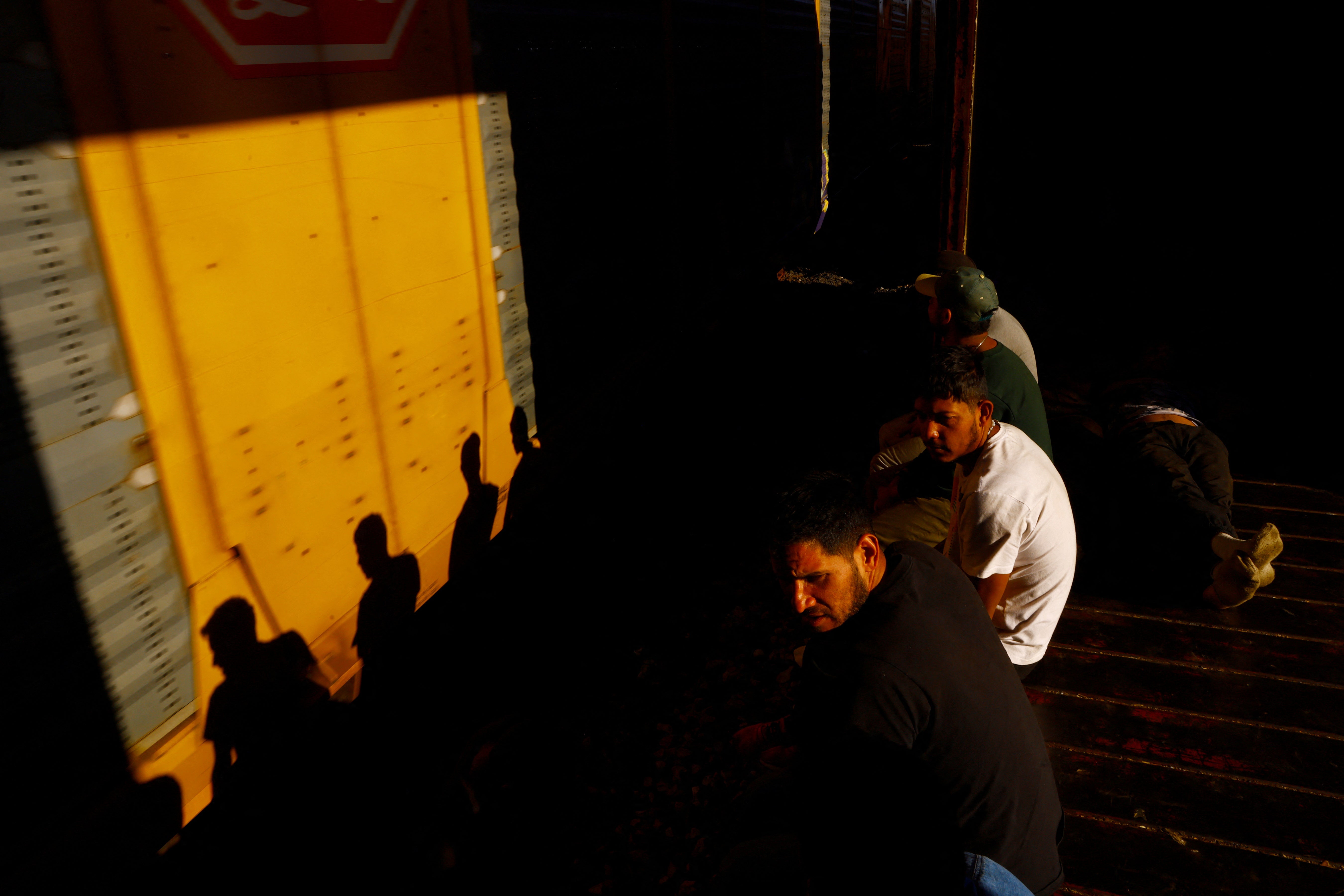 Migrants travel on a train, with the intention of reaching the United States, on the outskirts of Ciudad Juarez