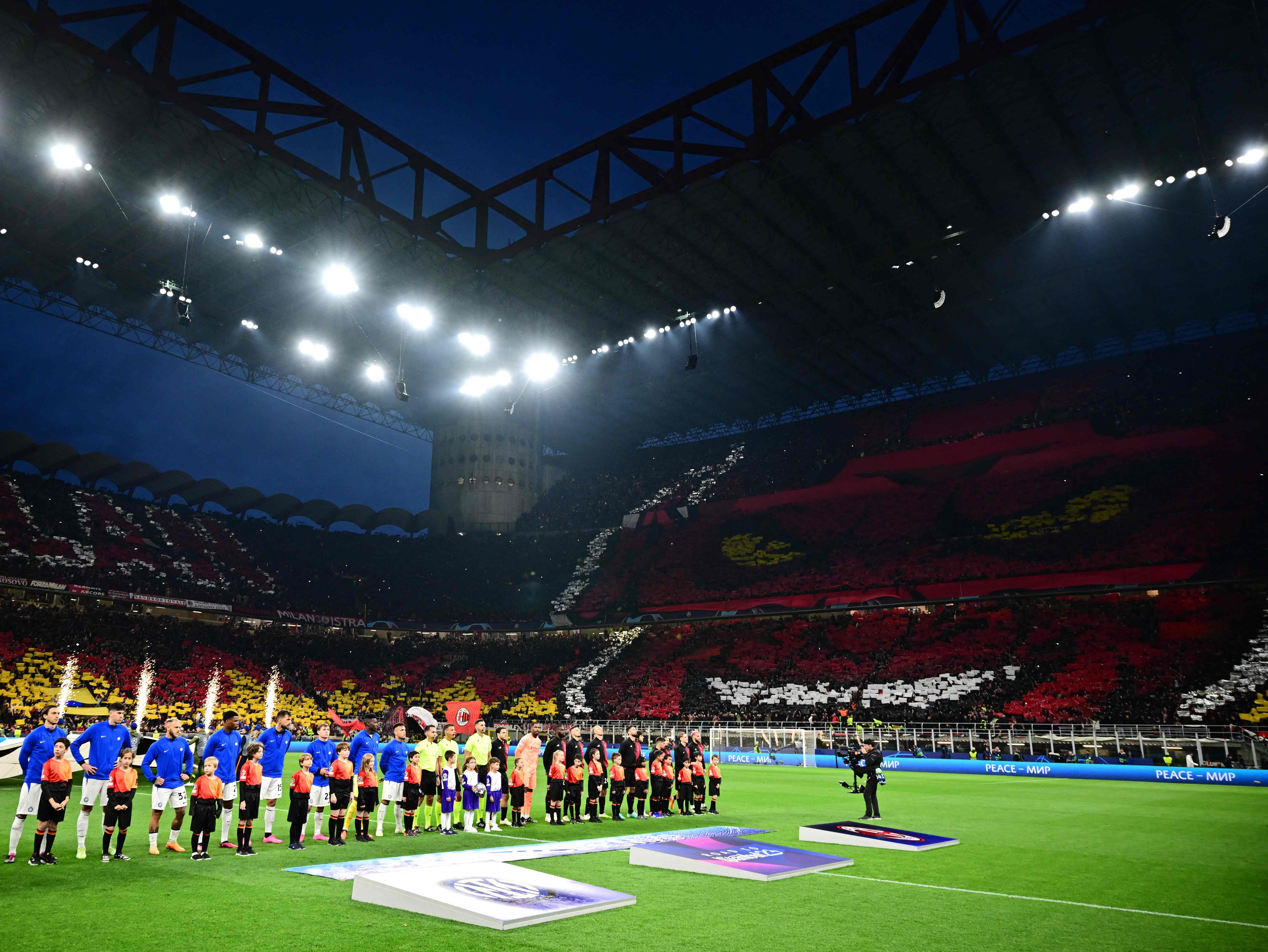Inter players and AC Milan players line up prior to the Champions League semi-final first leg