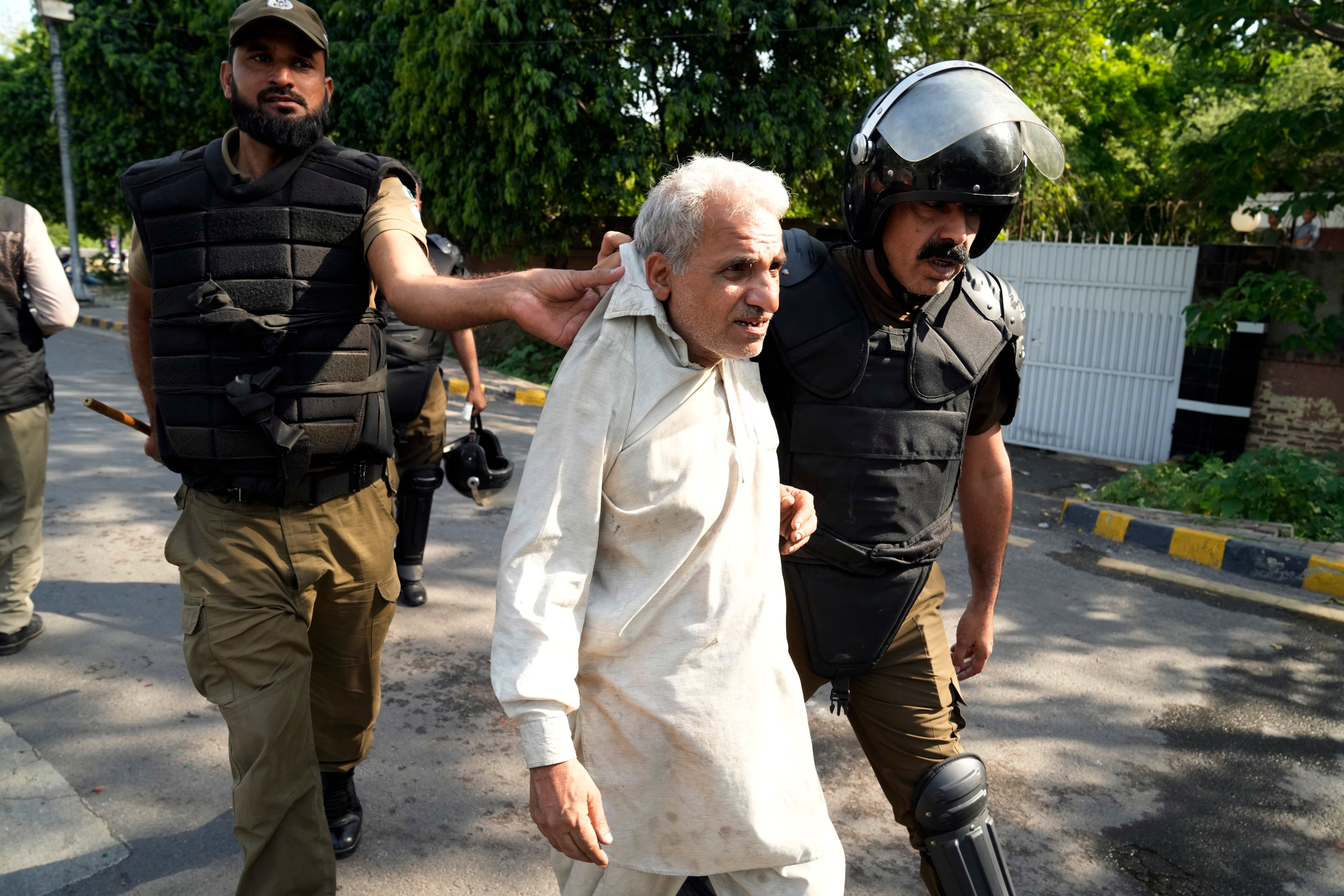 Police detain a supporter of Imran Khan who along with others are protesting against the arrest of their leader, in Lahore, Pakistan, Wednesday, 10 May 2023