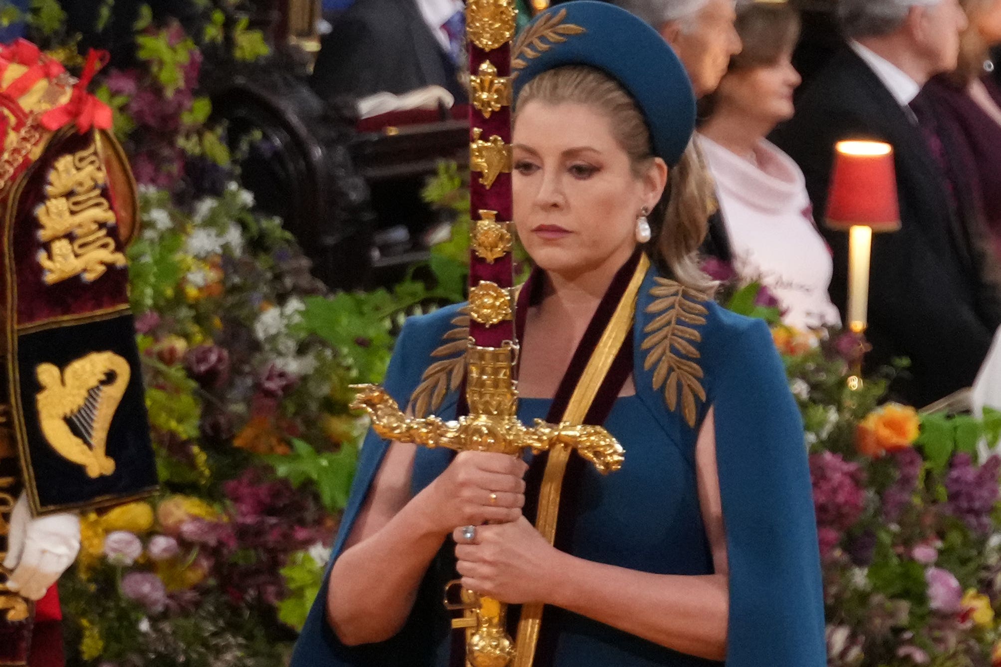 Penny Mordaunt carrying the sword of state at the coronation of King Charles III in May 2023