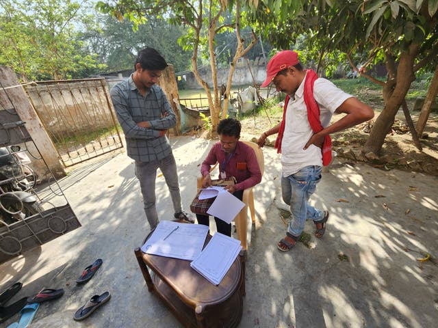 <p>Alok Kumar (left), census taker Satyadeo Paswa and Kiran Chaudhary try to decipher the codes in the Bihar caste survey</p>