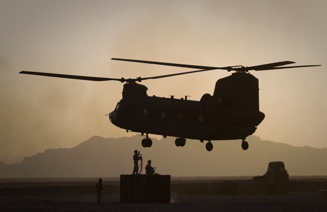 <p>US Marines direct a Chinook helicopter in Helmand province in 2011 </p>