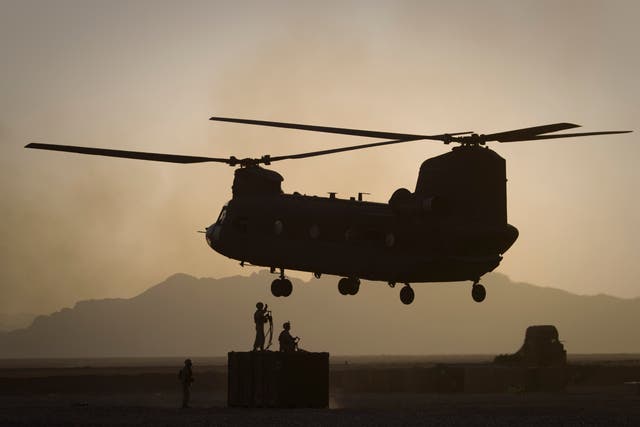 <p>US Marines direct a Chinook helicopter in Helmand province in 2011 </p>