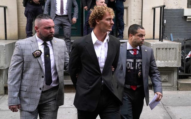 <p>US Marine veteran Daniel Penny (center) is walked out of the New York Police Department 5th Precinct in Lower Manhattan, May 12, 2023</p>