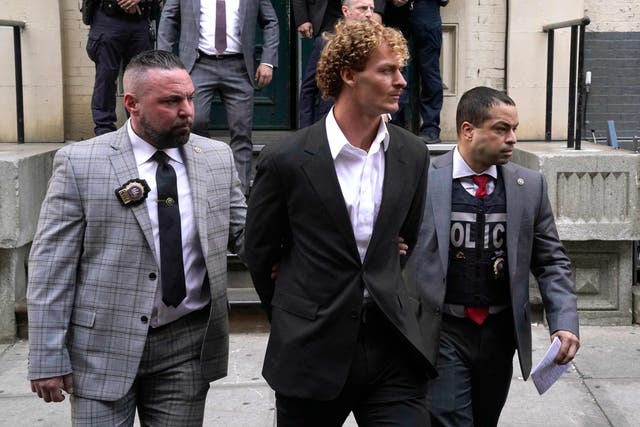 <p>US Marine veteran Daniel Penny (center) is walked out of the New York Police Department 5th Precinct in Lower Manhattan, May 12, 2023</p>