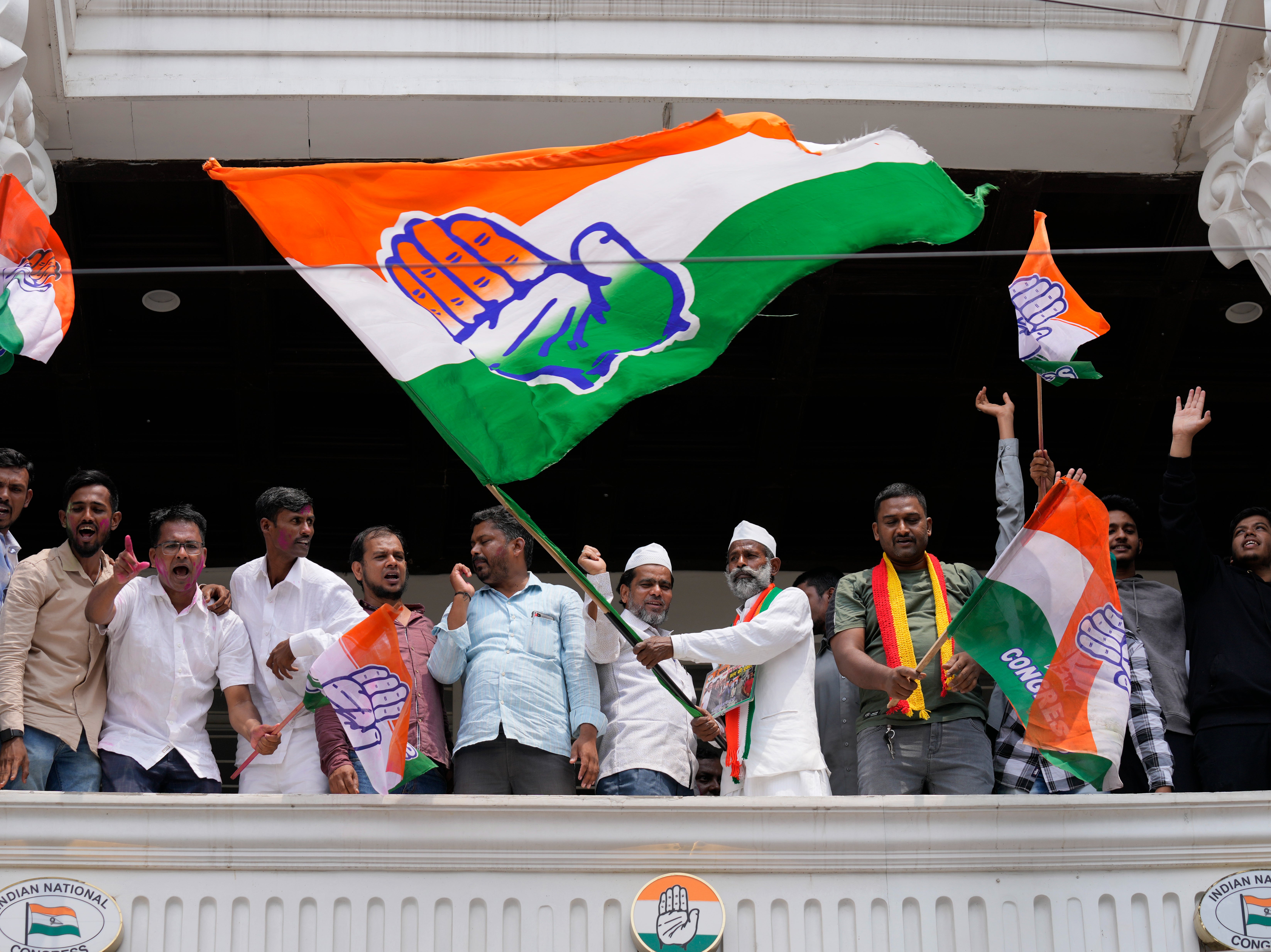Supporters of opposition Congress party wave flags to celebrate in Karnataka