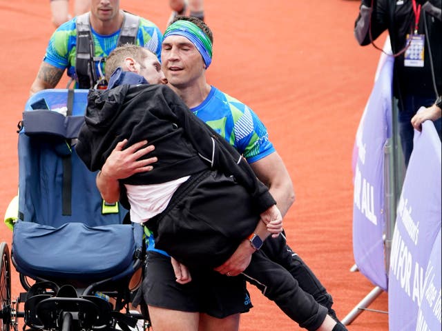 <p>Kevin Sinfield carried Rob Burrow over the line at the Leeds Marathon</p>