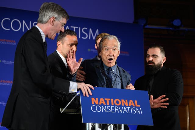 <p>A heckler is dragged away after interrupting Jacob Rees-Mogg at the National Conservatism conference in London on Monday</p>