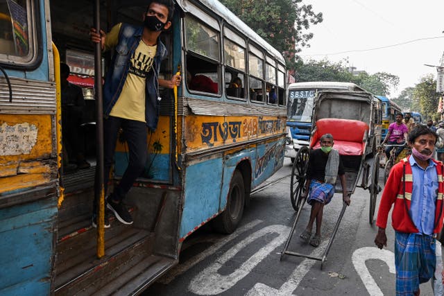 <p>Representational image of a commuter peeping out of a bus stuck in traffic in Kolkata on 31 January 2022</p>