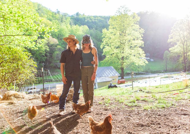 <p>Alex O’Neill, left, and Jess McClelland on their 16-acre property in Triplett, North Carolina</p>