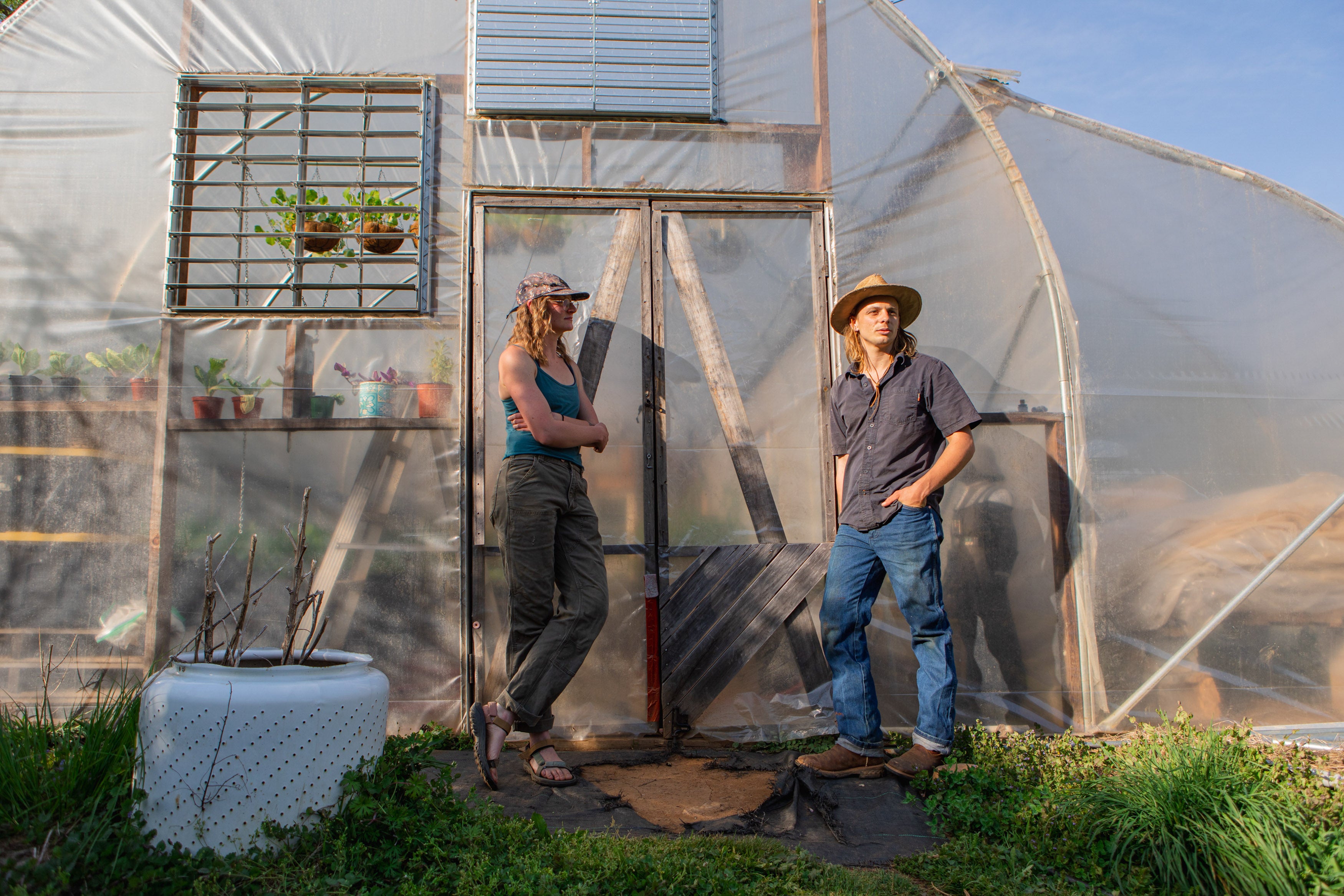 McClelland and O’Neill by a neighbour’s greenhouse in Triplett. Their neighbour is allowing them to borrow the space to house their plants during the off-season