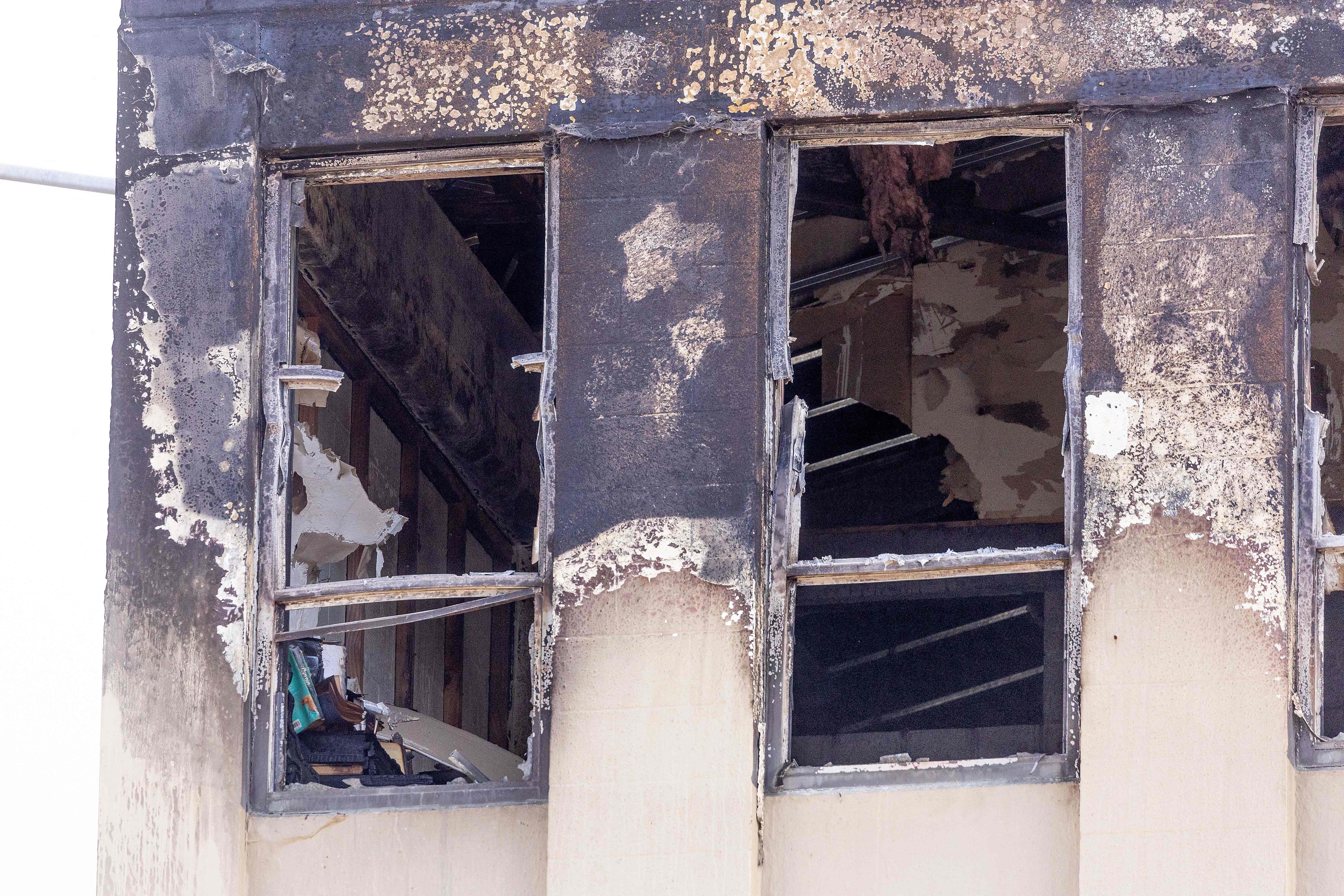 A burnt out window is seen at the Loafers Lodge hostel in the aftermath of a fire in the suburb of Newtown