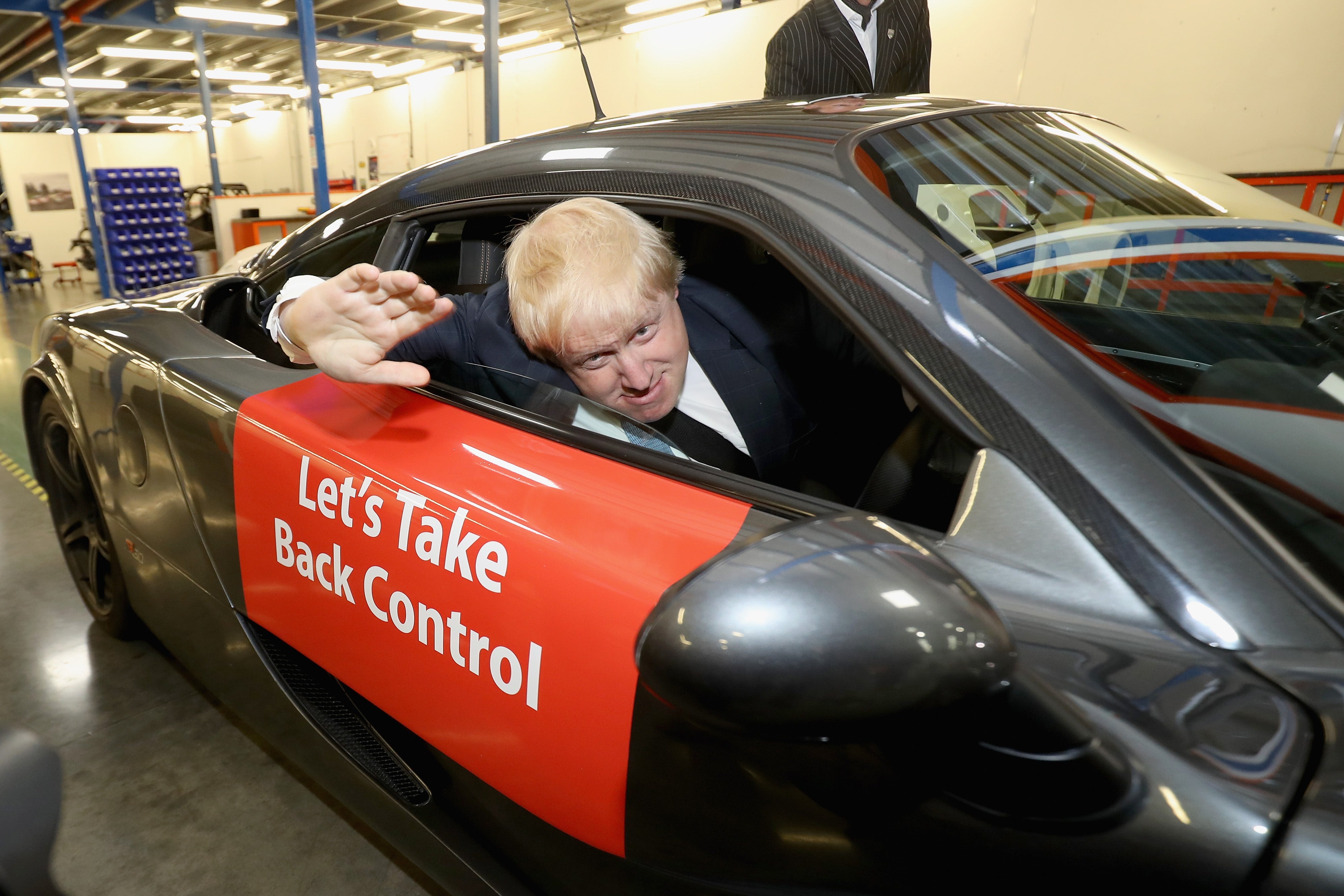 Boris Johnson MP drives a sports car during the Brexit Battle Bus tour in Leeds in May 2016