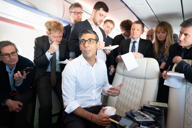 Prime Minister Rishi Sunak holds a huddle with political journalists on board a government plane as he heads to Japan to attend the G7 summit in Hiroshima (Stefan Rousseau/PA)