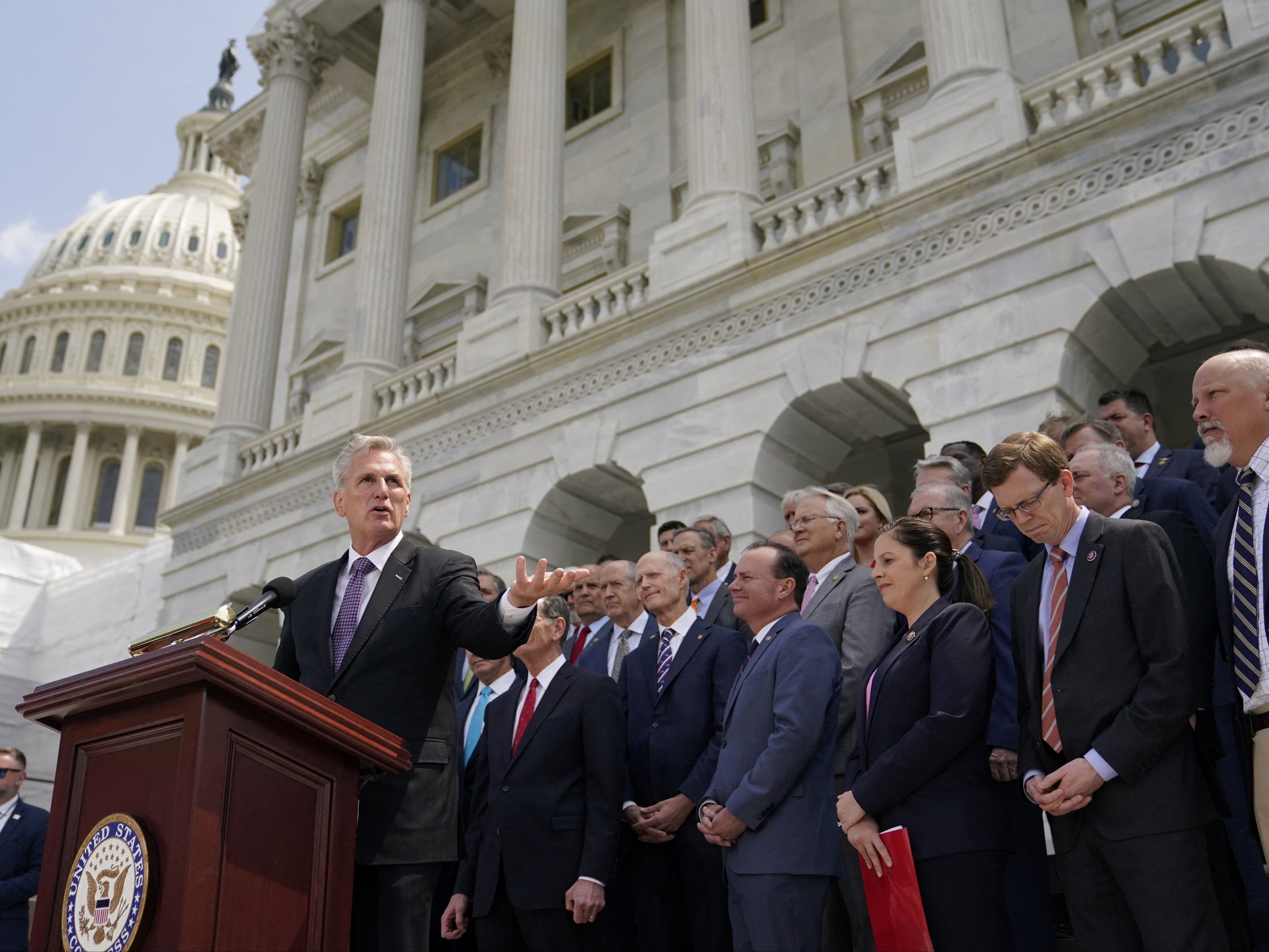 Speaker of the House Kevin McCarthy speaks to reporters as he stands with Congressional Republicans from both the US House and Senate during an event about debt ceiling negotiations