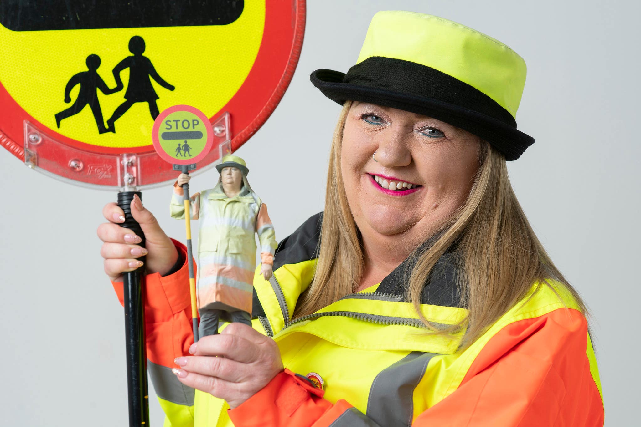 Lollipop lady Sandy Cox with her action figure (Ady Kerry/PinPep/PA)