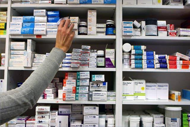 A pharmacist stocking shelves at a chemist (Julien Behal/PA)