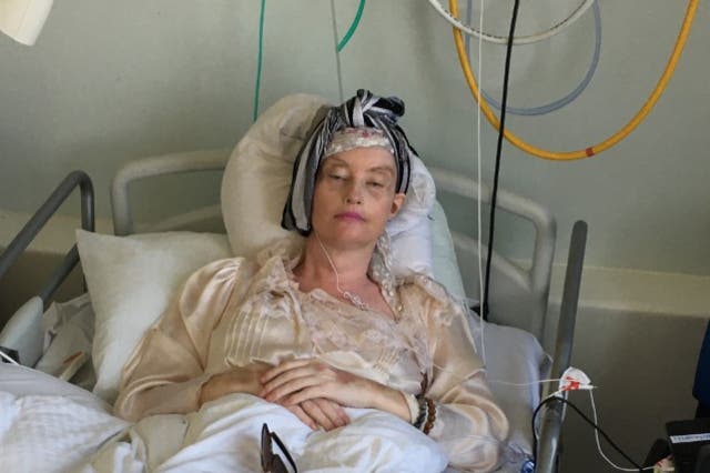 <p>Lauren Harries in hospital following brain surgery</p>