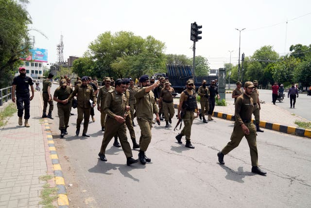 <p>Police officers patrol around the residence of Pakistan's former prime minister Imran Khan, in Lahore, Pakistan, Thursday, 18 May 2023</p>
