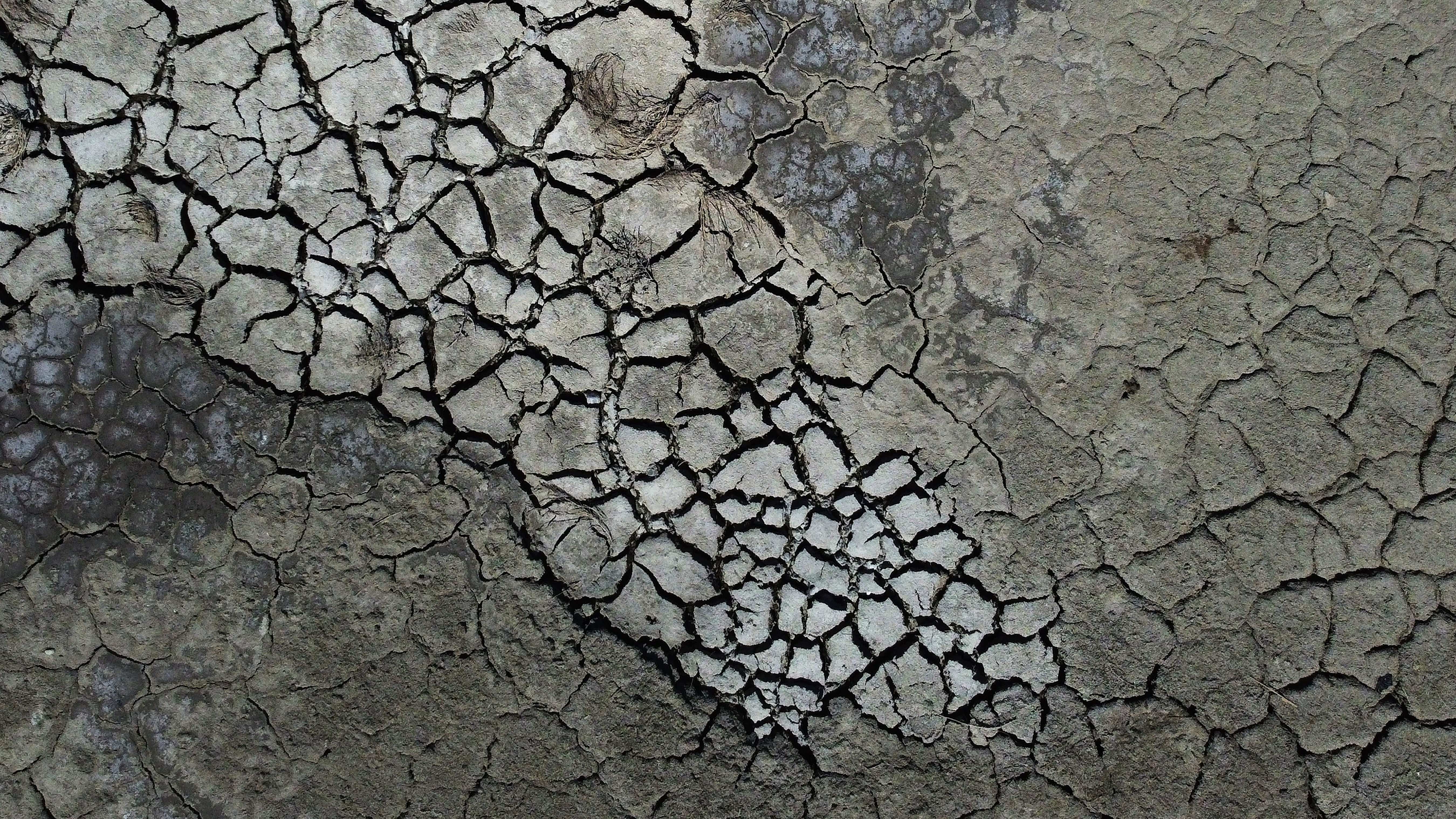 Dried cracked mud is visible at the Antelope Island Marina due to low water levels on the Great Salt Lake, near Syracuse, Utah