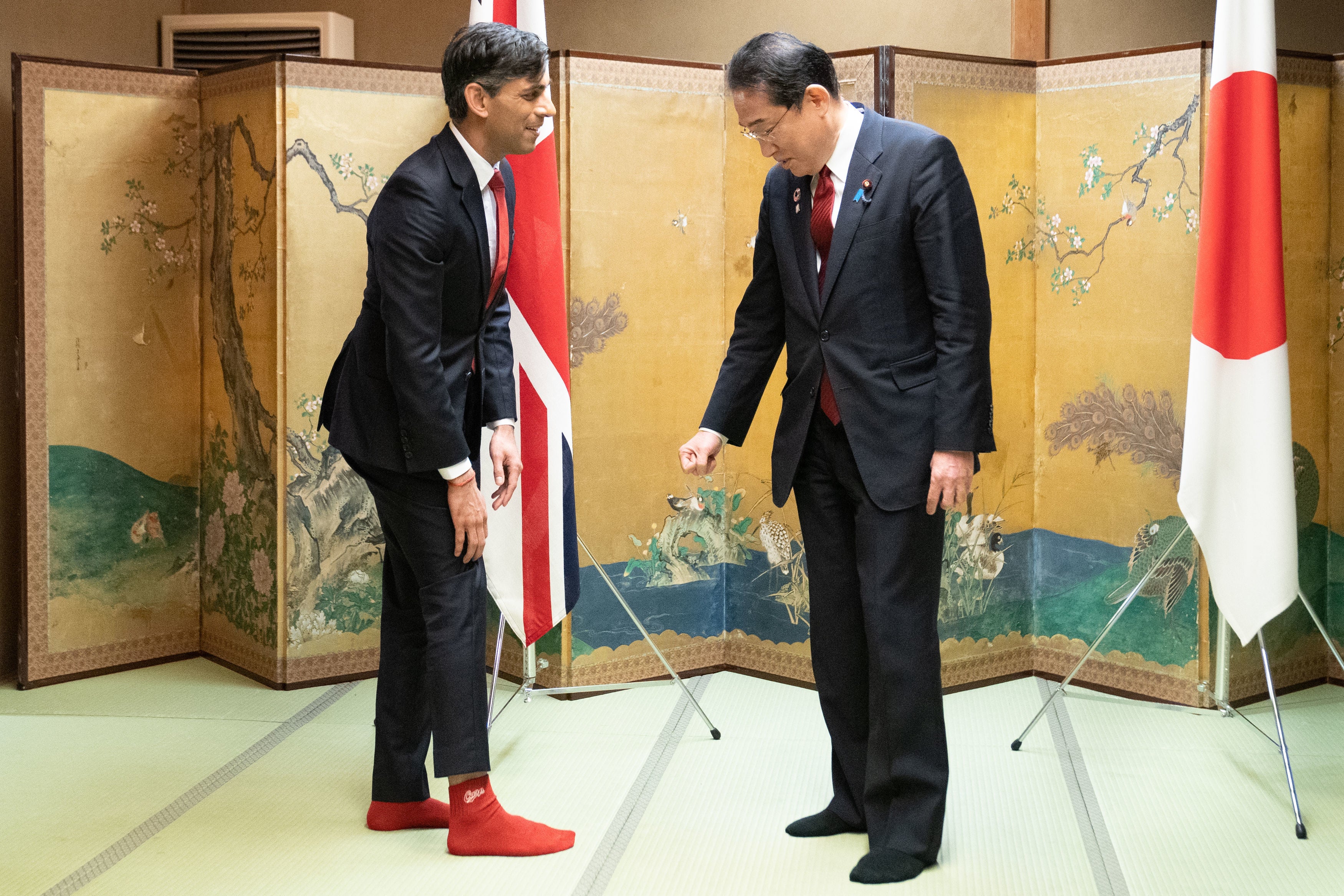 Japan’s prime minister Fumio Kishida admires Rishi Sunak’s socks, which feature the name of his favourite baseball team, Hiroshima Toyo Carp