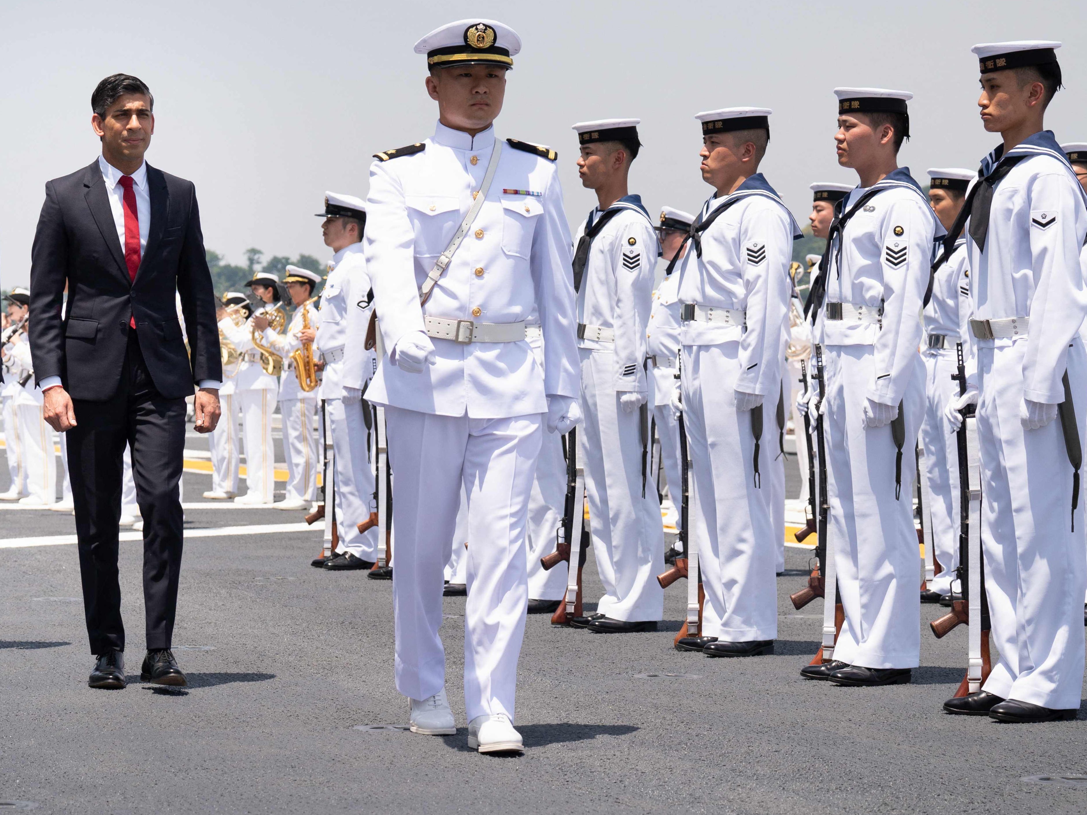 Rishi Sunak inspects the guard of honour on Japanese aircraft carrier JS Izumo