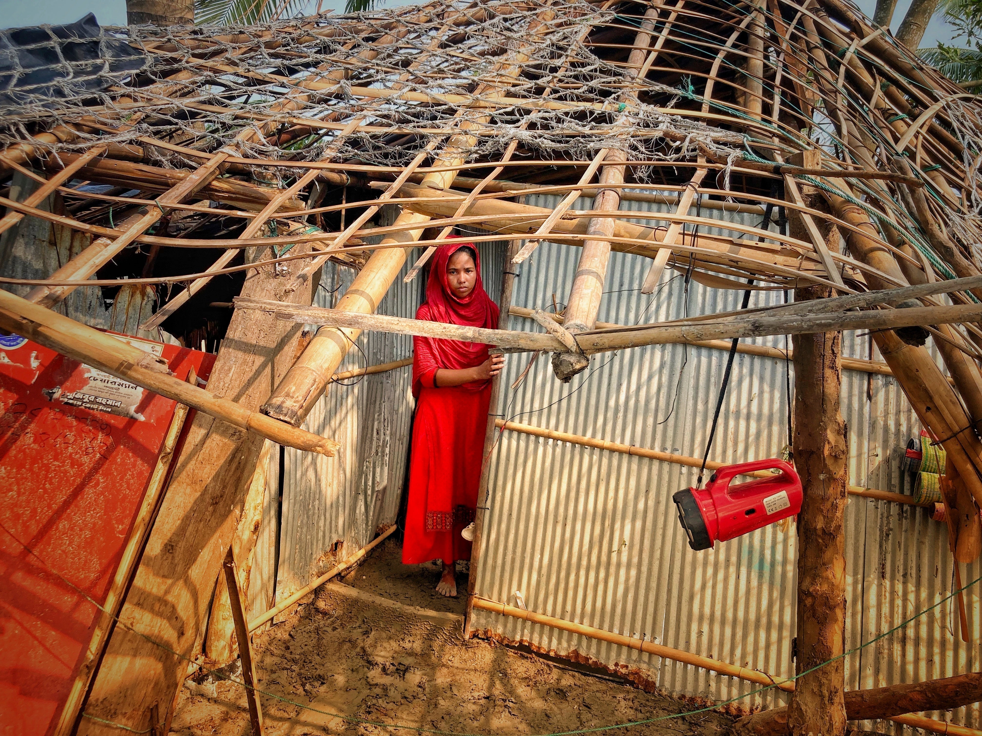 A woman surveys the damage caused to her home by Cyclone Mocha at Saint Martin island in Cox's Bazar, Bangladesh, in May, with the storm causing “widespread devastation”
