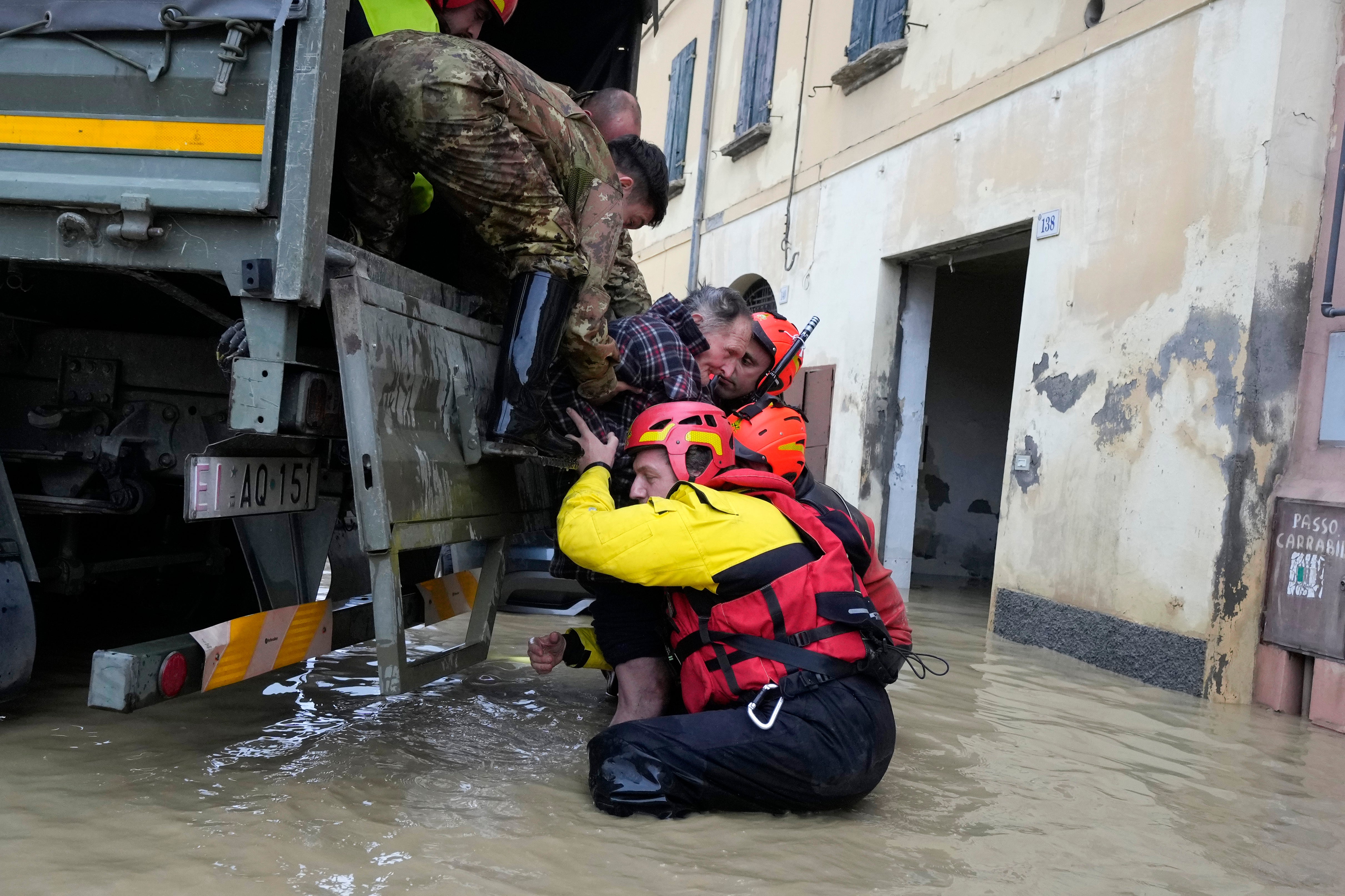 Firefighters rescue an elderly man in the flooded village of Castel Bolognese, Italy, in May