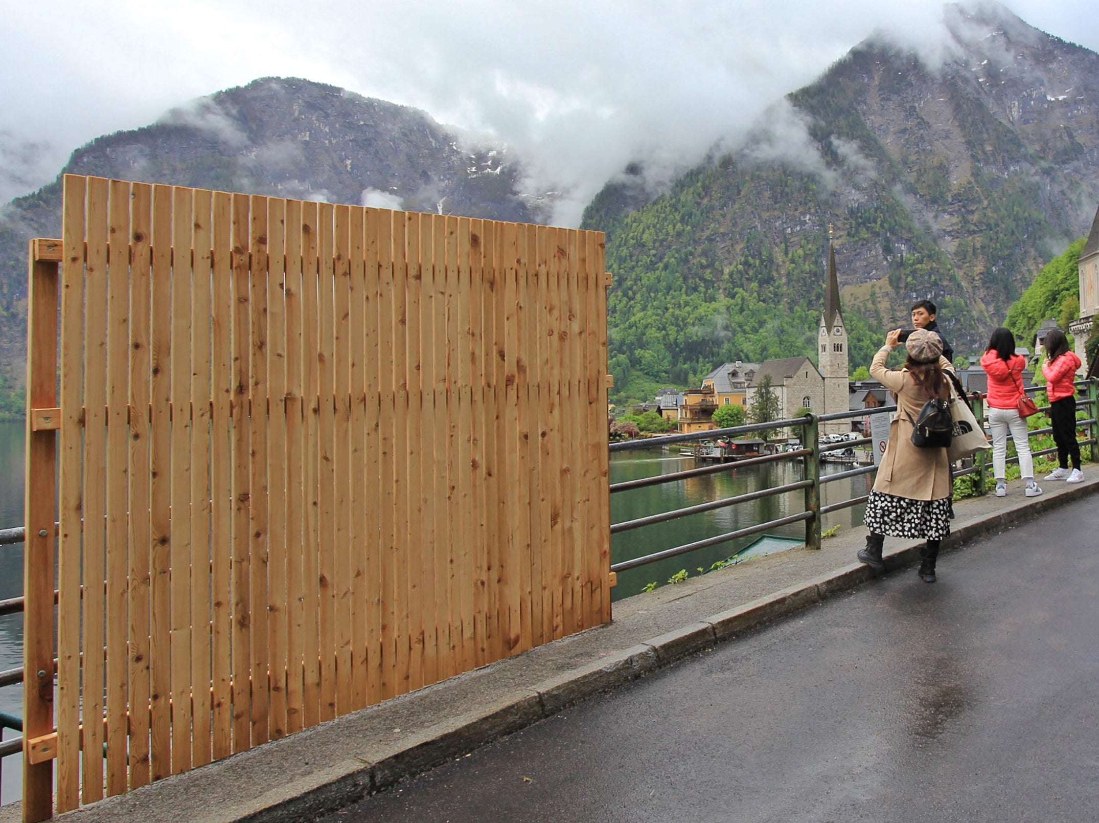 <p>A provisional wooden fence is partially blocking the view in Hallstatt</p>