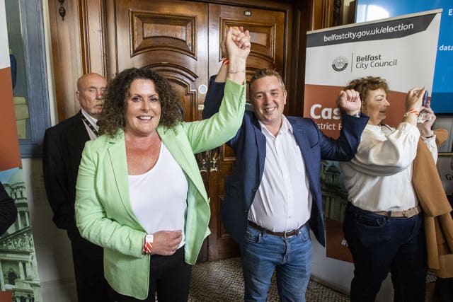 Sinn Fein candidates Bronach Anglin (left) and Conor Maskey (centre) celebrate after being been elected to serve as Belfast City Councillors, during the 2023 local election count at Belfast City Hall (Liam McBurney/PA)