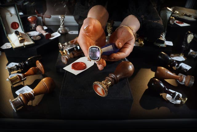 Sir Walter Scott’s desk seal (held) was part of a private collection of seals (Stewart Attwood/PA)