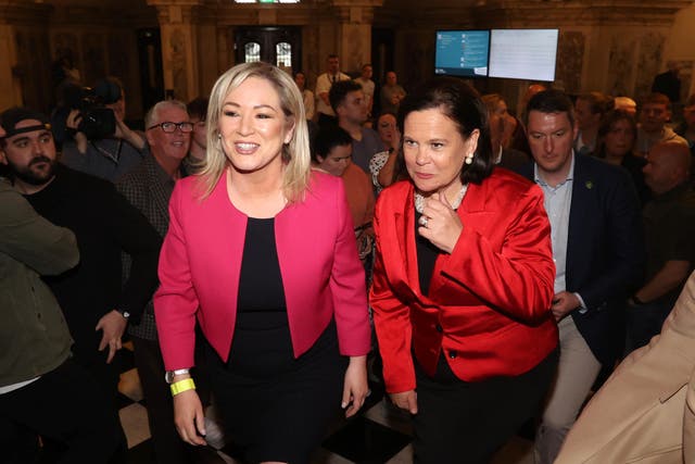 Sinn Fein’s Michelle O’Neill, left, and Mary Lou McDonald arrive at Belfast City Hall as results continue to come in for the Northern Ireland local elections (Liam McBurney/PA)