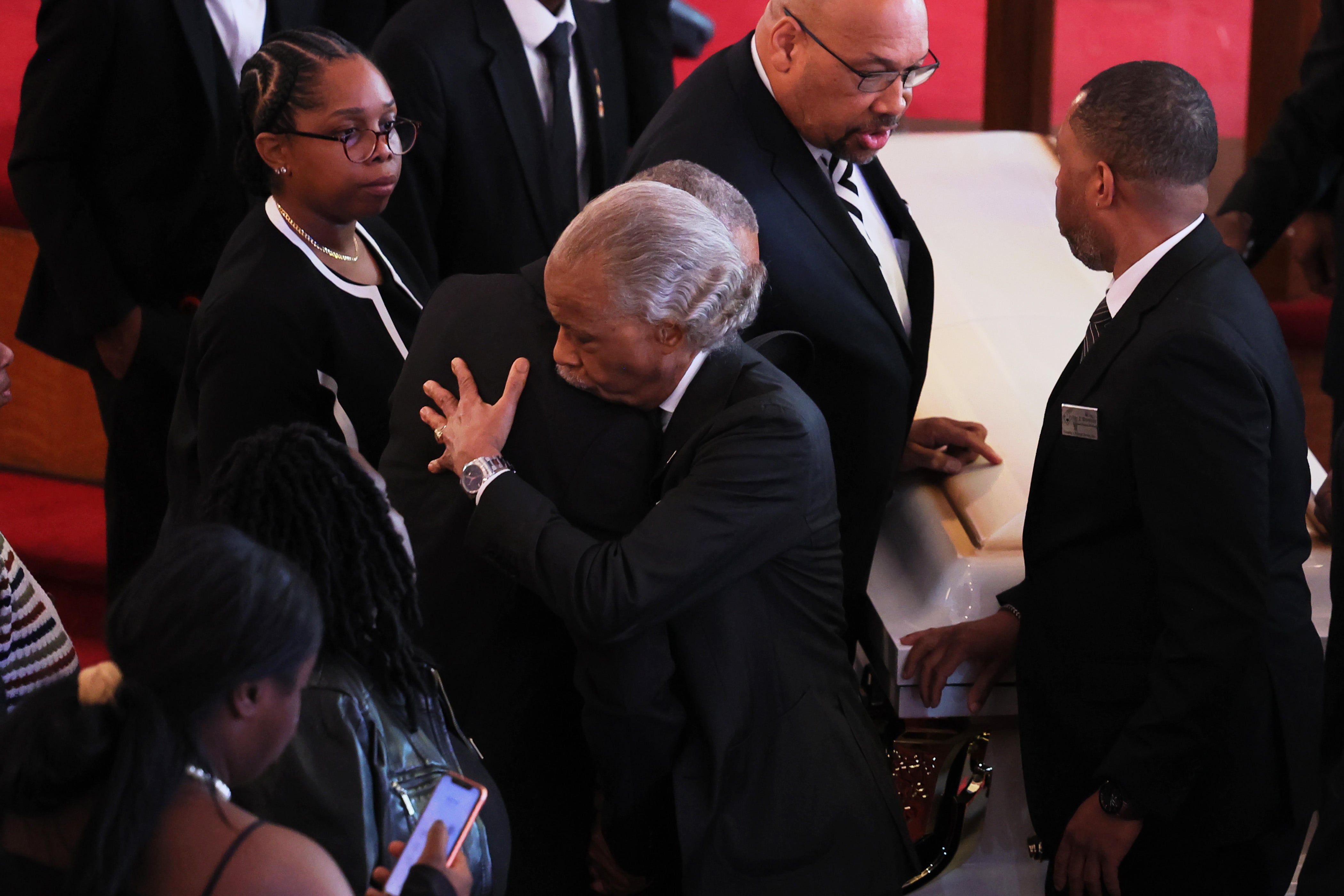 Andre Zachery, father of Jordan Neely, embraces the Reverend Al Sharpton at the conclusion of his son's public viewing and funeral service at Mount Neboh Baptist Church on May 19, 2023 in New York City