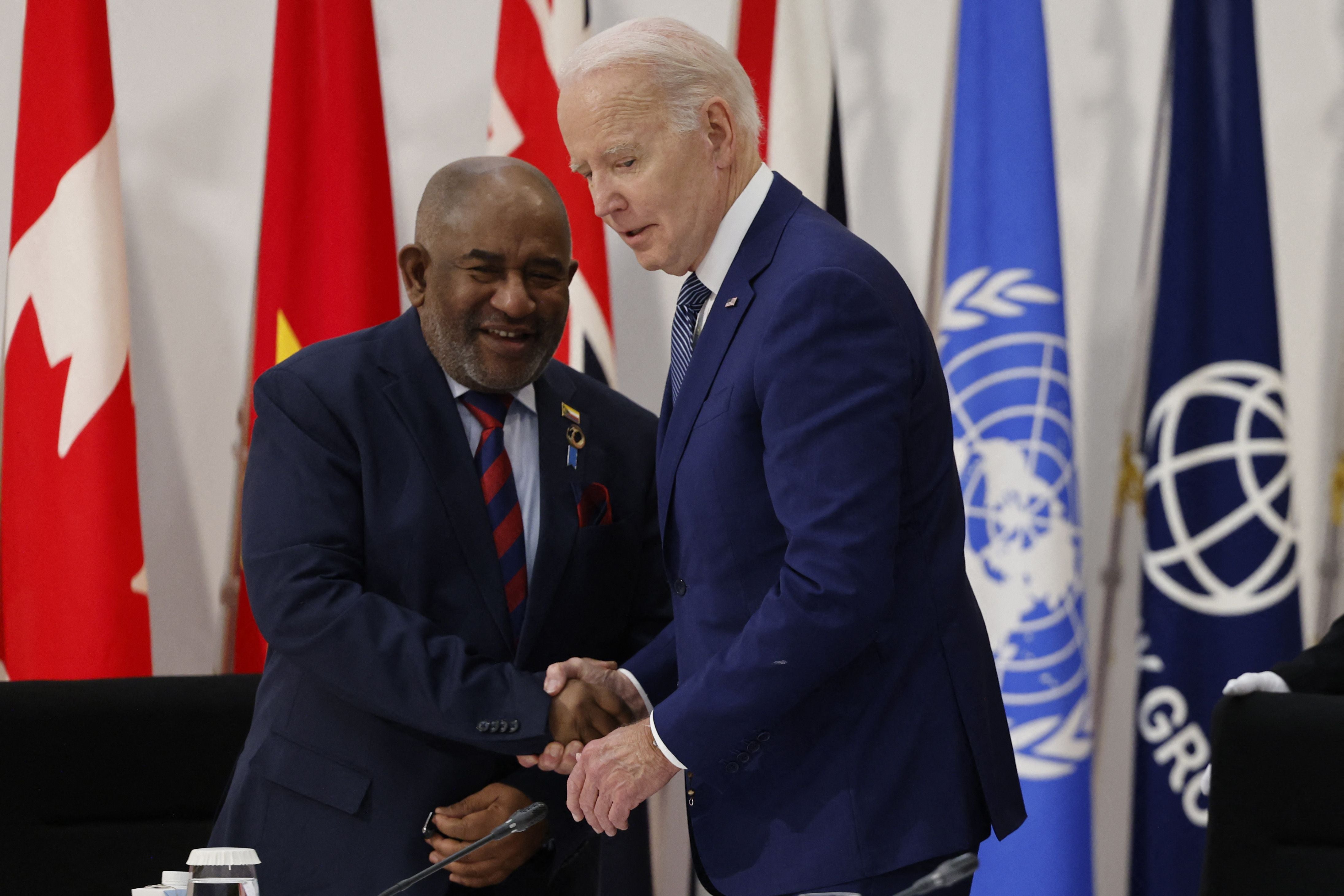 US president Joe Biden (R) greets Comoros president Azali Assoumani at a working session during the G7 Leaders' Summit in Hiroshima