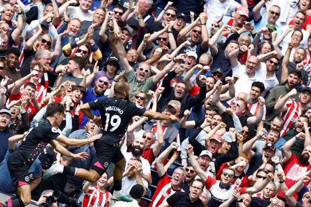 <p>Bryan Mbeumo celebrates scoring in front of the Brentford fans</p>