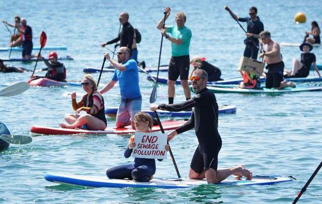 <p>Protesters take to the sea at Brighton West Pier in East Sussex, as charity Surfers Against Sewage demands an end to sewage discharges into UK bathing waters by 2030 (PA) </p>