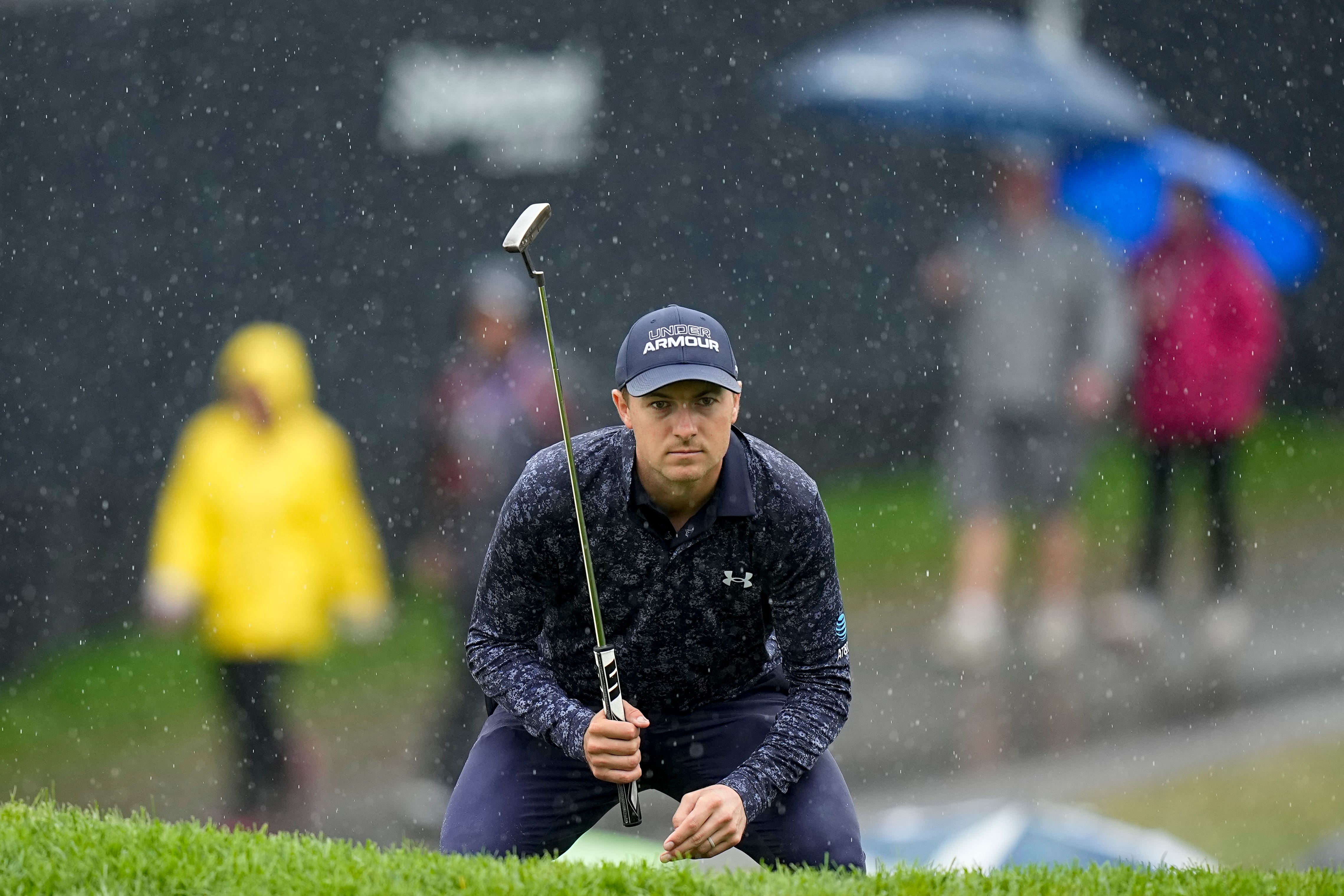 Jordan Spieth lines up a putt in the rain on the 18th hole during the third round of the US PGA Championship (Eric Gay/AP)