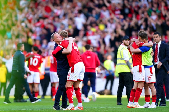 <p>Nottingham Forest manager Steve Cooper hugs defender Joe Worrall</p>