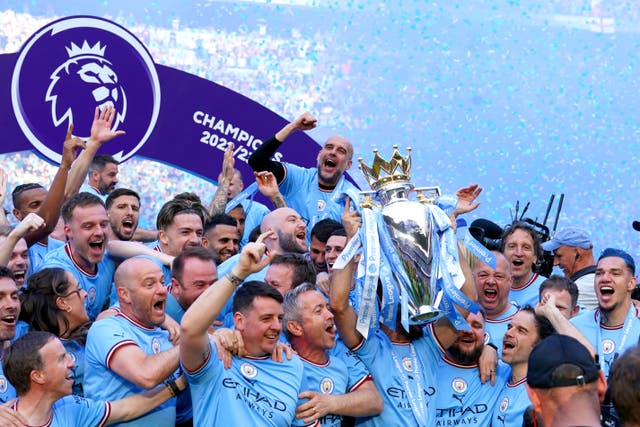Manchester City players and staff celebrate with the Premier League trophy (Martin Rickett/PA)