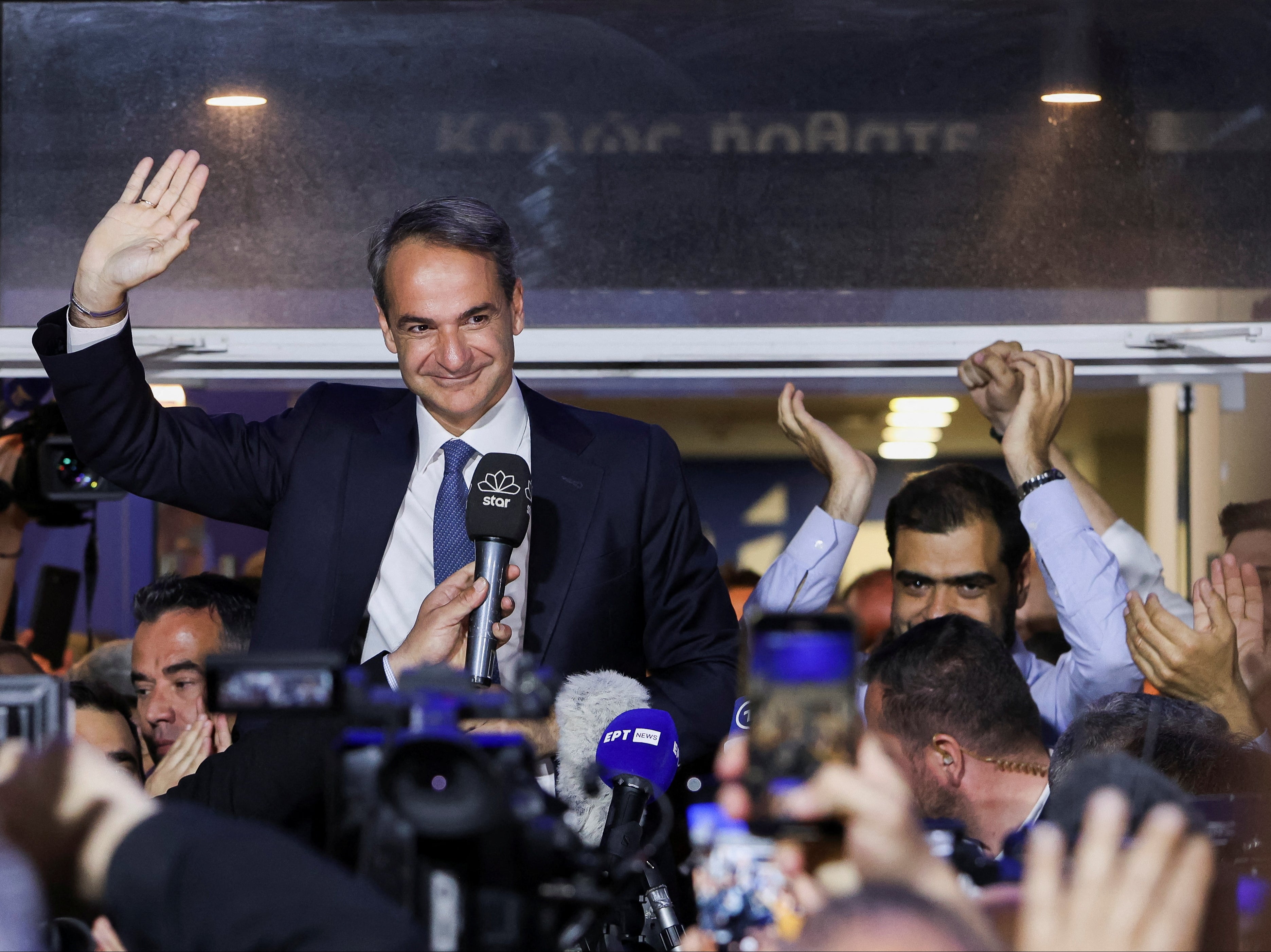 Greek prime minister and New Democracy conservative party leader Kyriakos Mitsotakis waves outside the party's headquarters, after the general election, in Athens, Greece