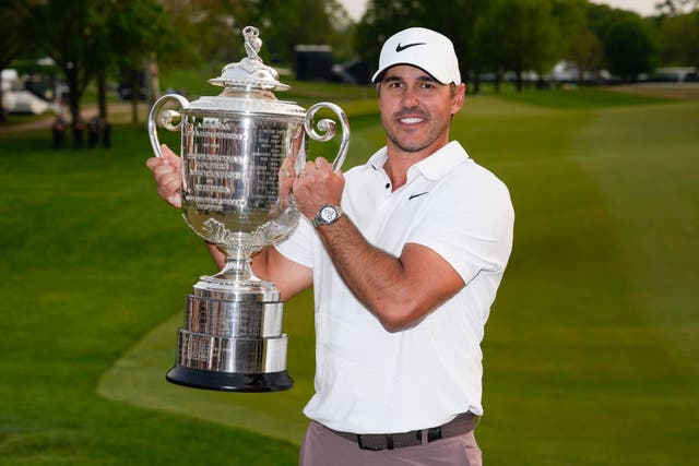 Brooks Koepka holds the Wanamaker Trophy after winning the US PGA Championship at Oak Hill (Seth Wenig/AP)