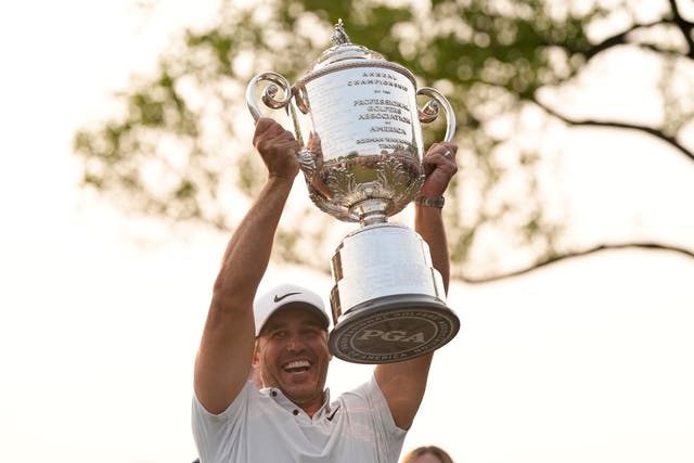 Brooks Koepka holds the Wanamaker trophy after winning the US PGA Championship for a third time (Abbie Parr/AP)