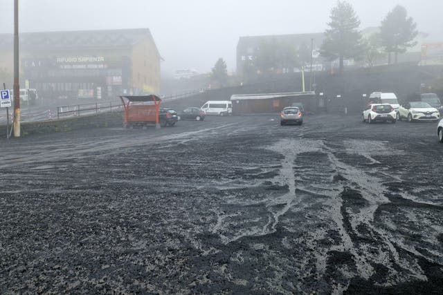 <p>A thick layer of ash coats a public square in Sicily after an eruption of Mount Etna</p>