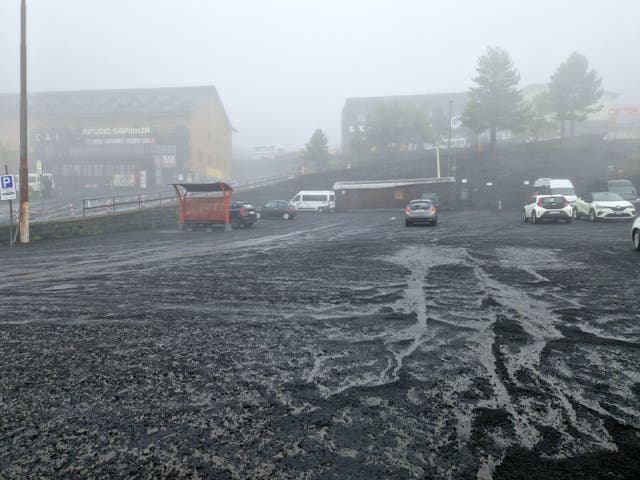 <p>A thick layer of ash coats a public square in Sicily after an eruption of Mount Etna</p>