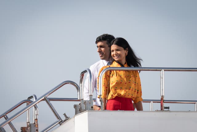 <p>British Prime Minister Rishi Sunak and wife Akshata Murty wave as they prepare to board a plane following the G7 summit</p>