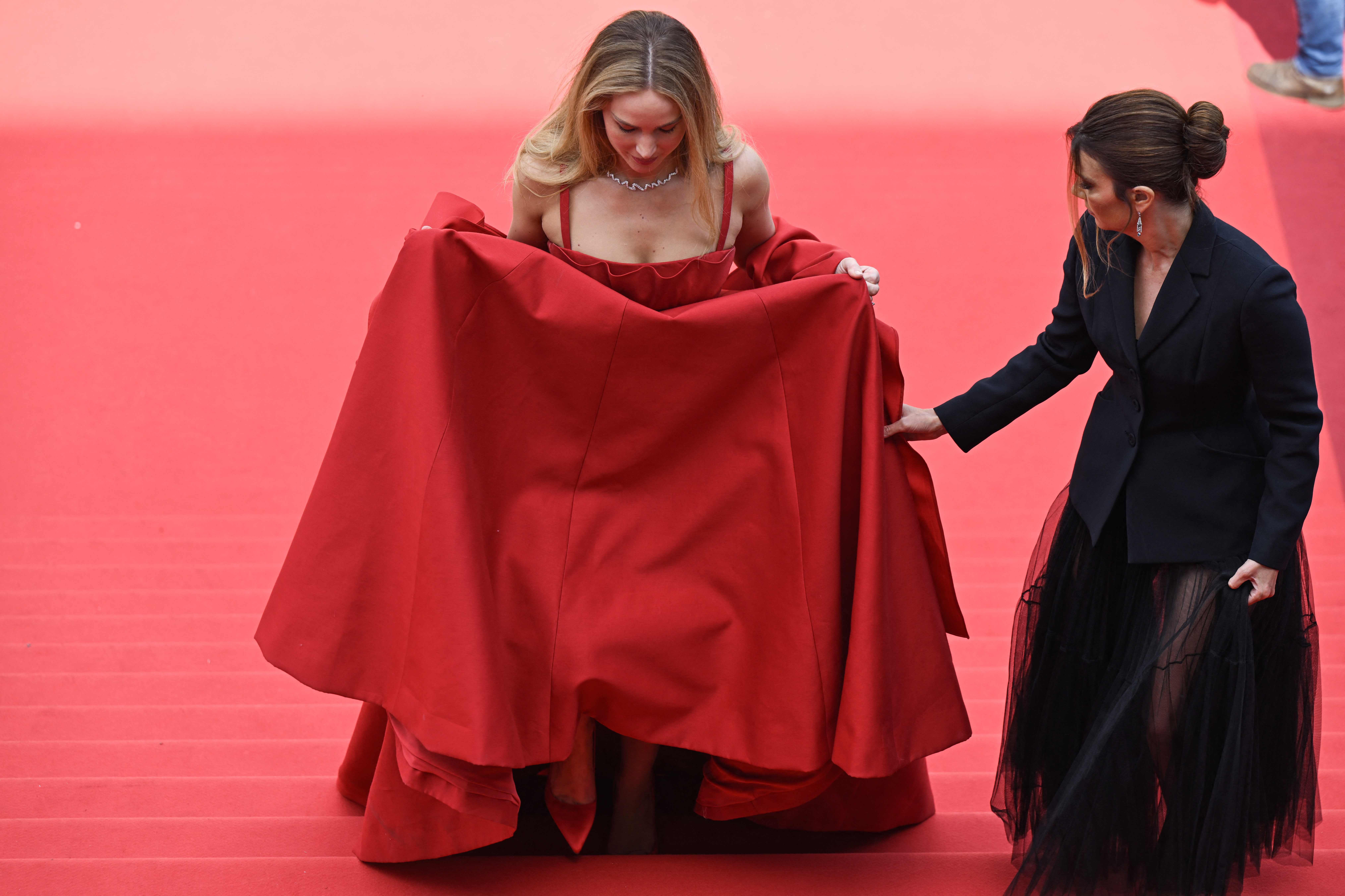 J.Law chose to trip down the red carpet in a red Christian Dior gown and flip flops
