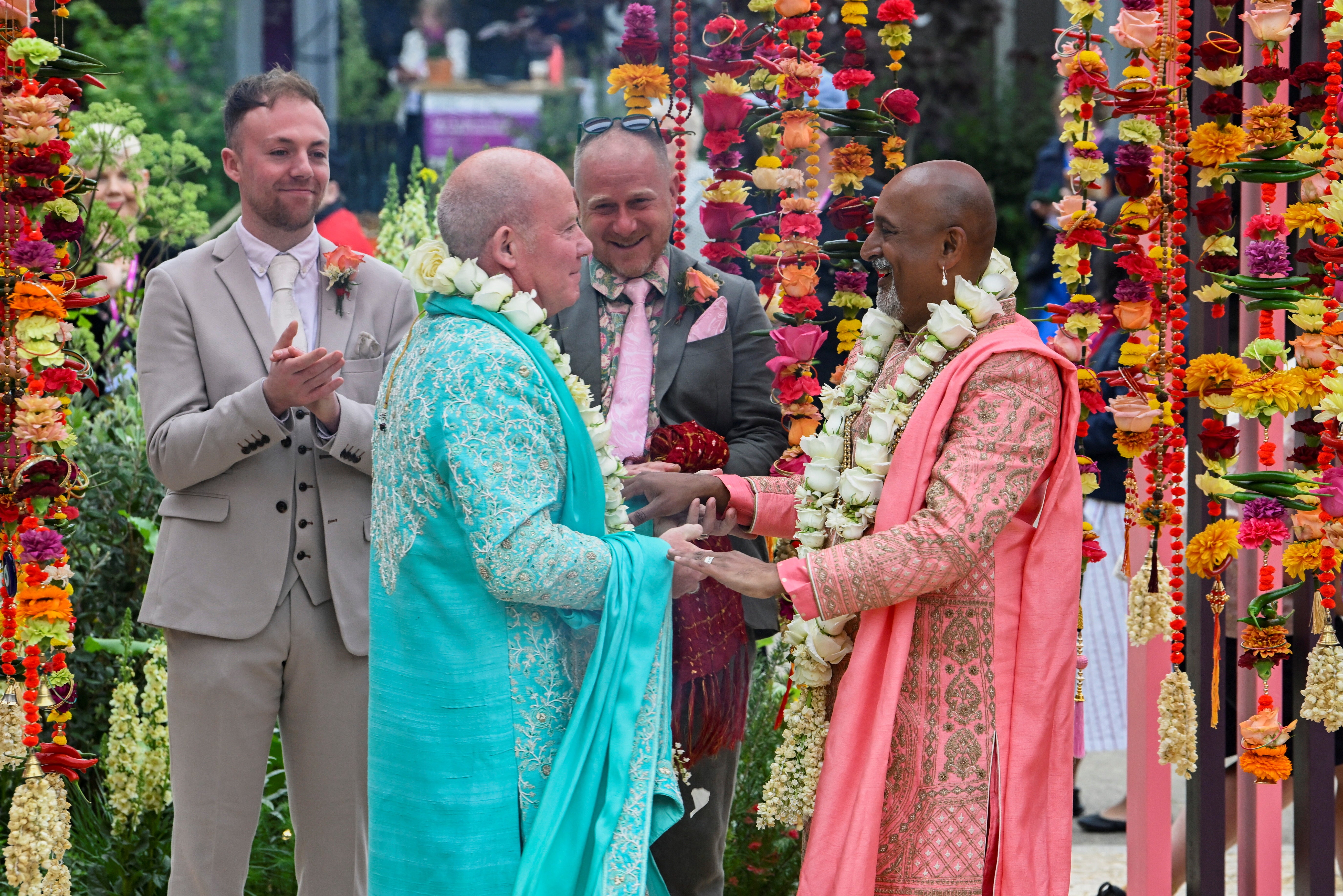 <p>Manoj Malde and Clive Gillmor marry in a civil wedding ceremony at the RHS and Eastern Eye Garden of Unity, the first wedding to take place at Chelsea Flower Show in London</p>