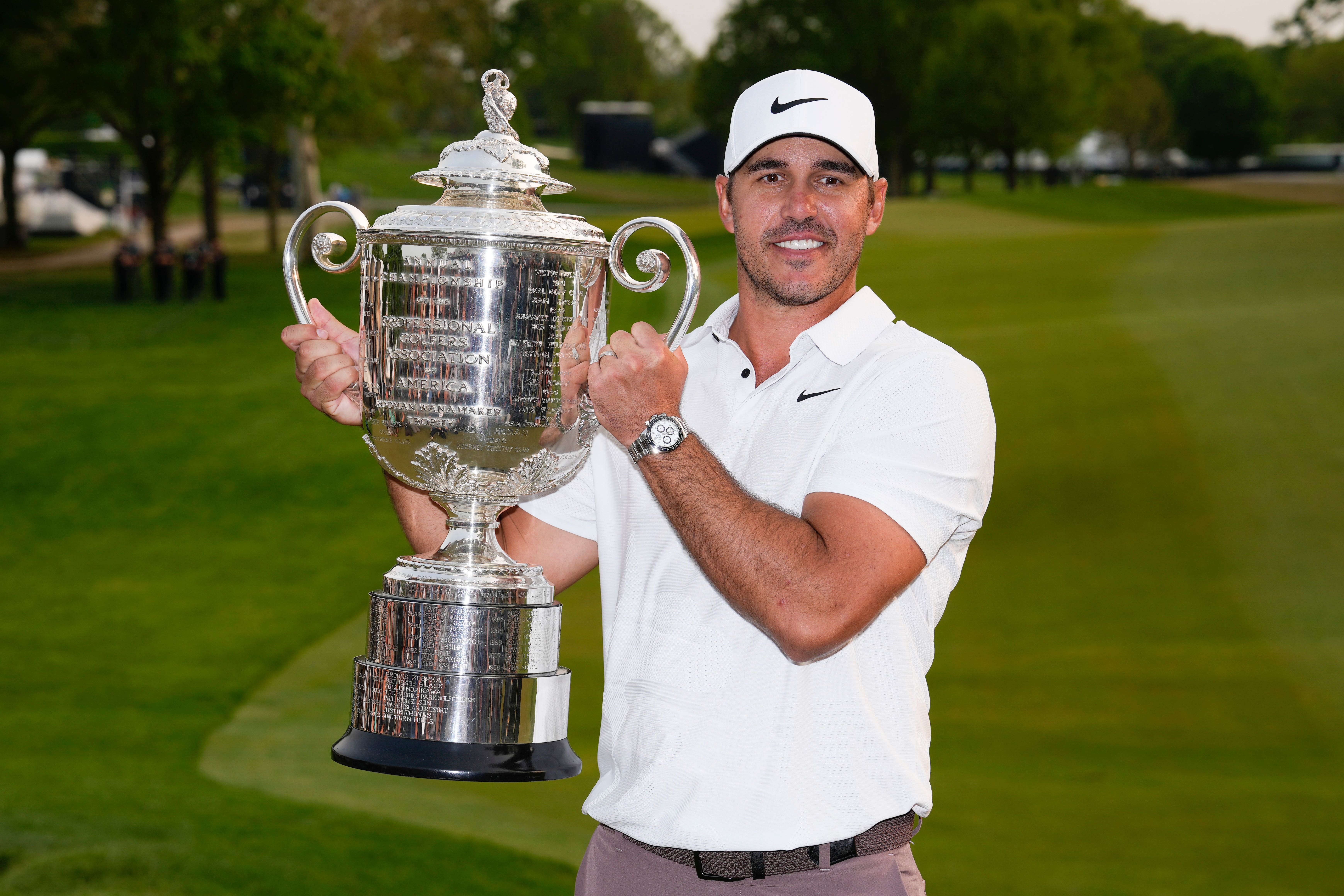 Brooks Koepka holds the Wanamaker trophy after winning the US PGA Championship for the third time (Seth Wenig/AP)